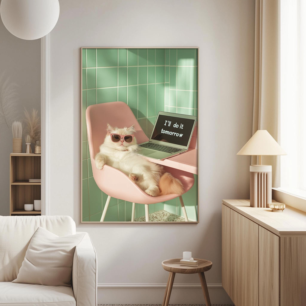 A white cat wearing sunglasses is sitting on a pink chair in a living room, with a laptop displaying the text "I'm do it tomorrow" in front of it.