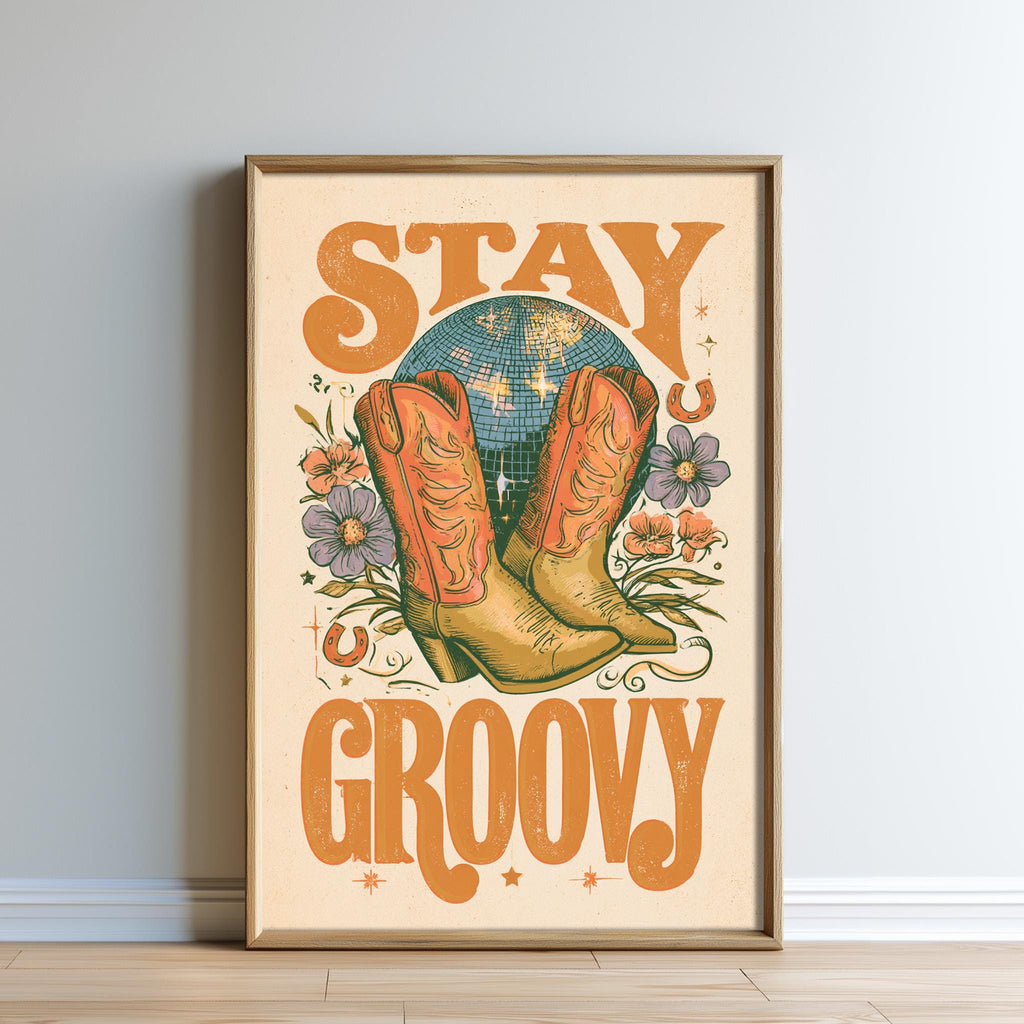 The image is a framed poster with a vintage-style design featuring a disco ball, cowboy boots, flowers, and the text "STAY GROOVY".