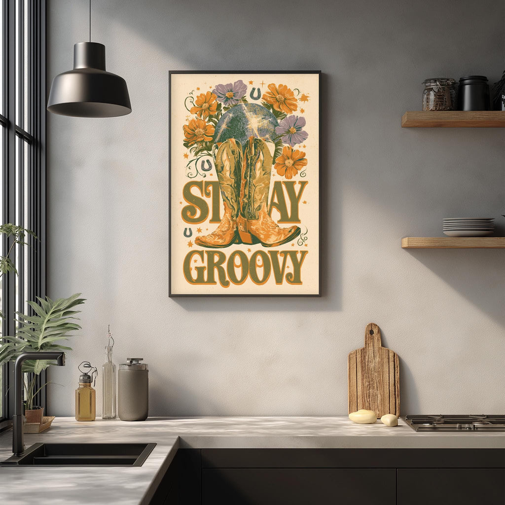 a framed poster with the text "STAY GROOVY" and an illustration of a pair of yellow boots with flowers on the wall above a kitchen counter.
