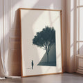 a large framed picture of a tree with a person standing in front of it, positioned in a corner of a room with a window.