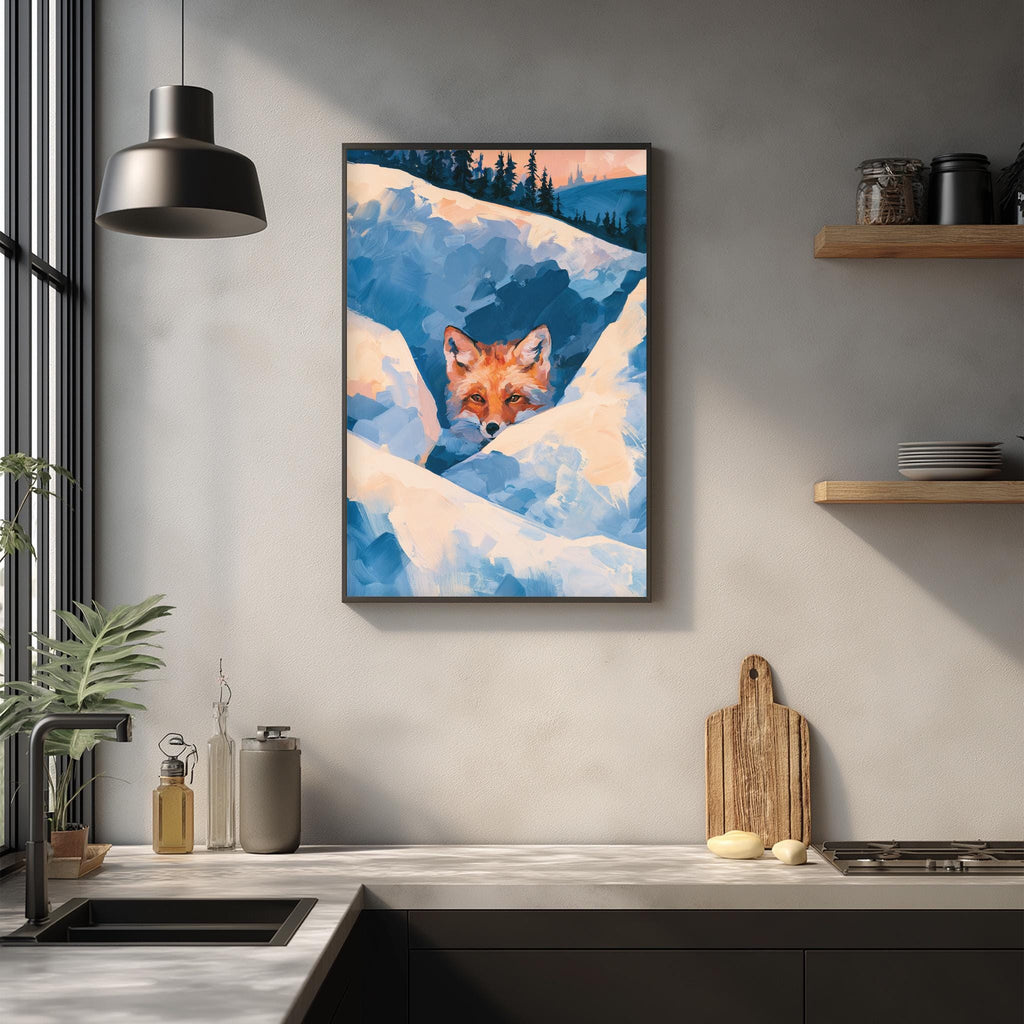 a framed painting of a fox peeking out from behind a snowy landscape, hanging on a wall above a kitchen counter.