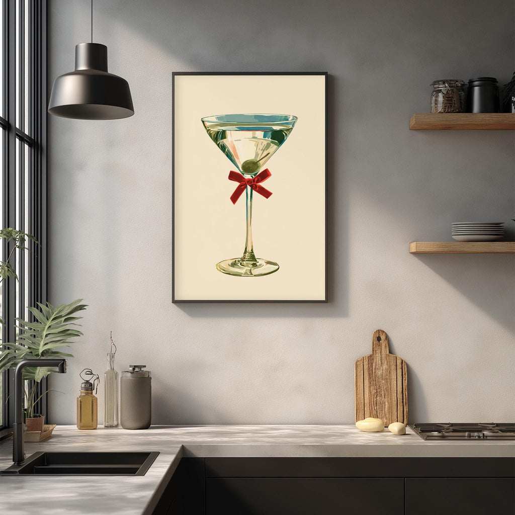 a framed illustration of a martini glass with a green olive on a kitchen counter.
