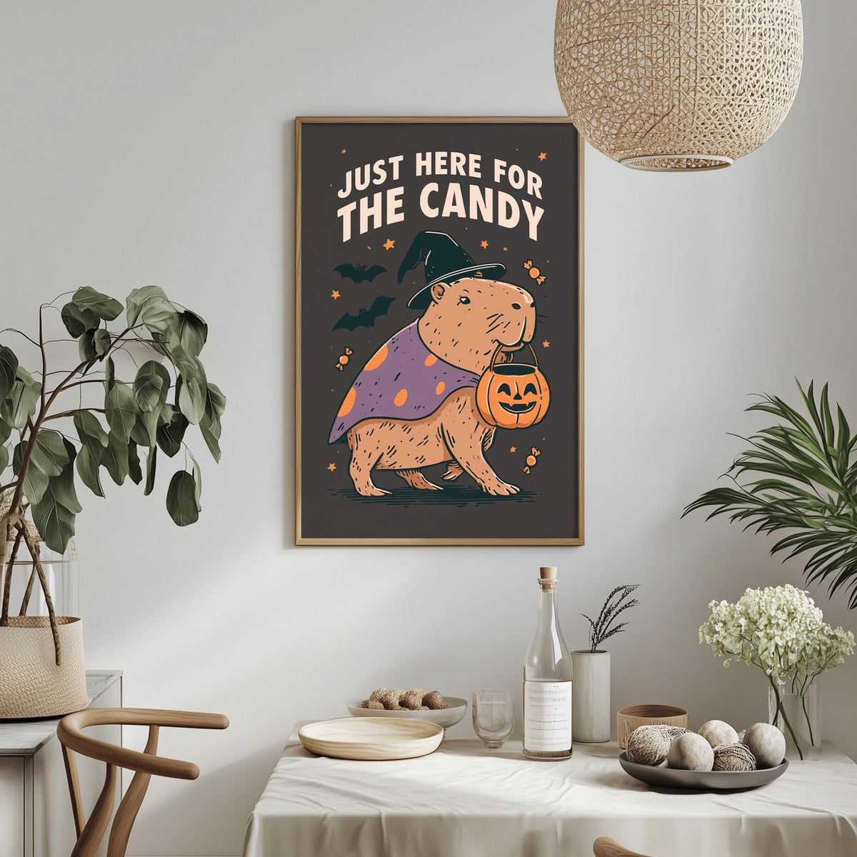 a Halloween-themed poster with a cartoon character dressed as a witch, holding a pumpkin and wearing a witch's hat. The poster is hung on a wall above a dining table with various Halloween-themed decorations and items, such as a bowl of candy, a bottle, and a vase.