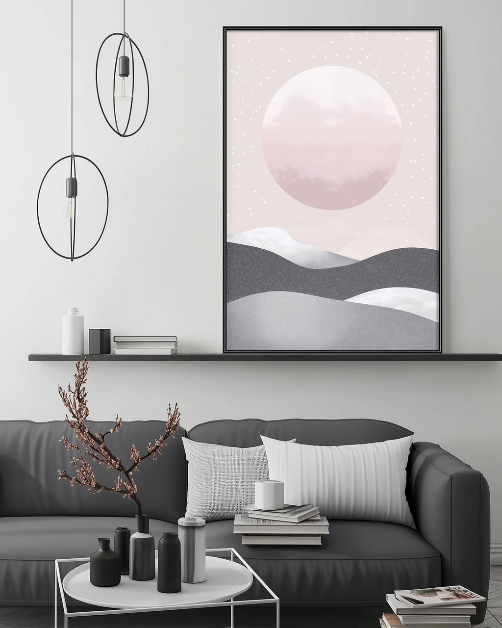 a modern living room with a gray sofa, a coffee table, and a large framed poster of a landscape with a large moon and stars on the wall.
