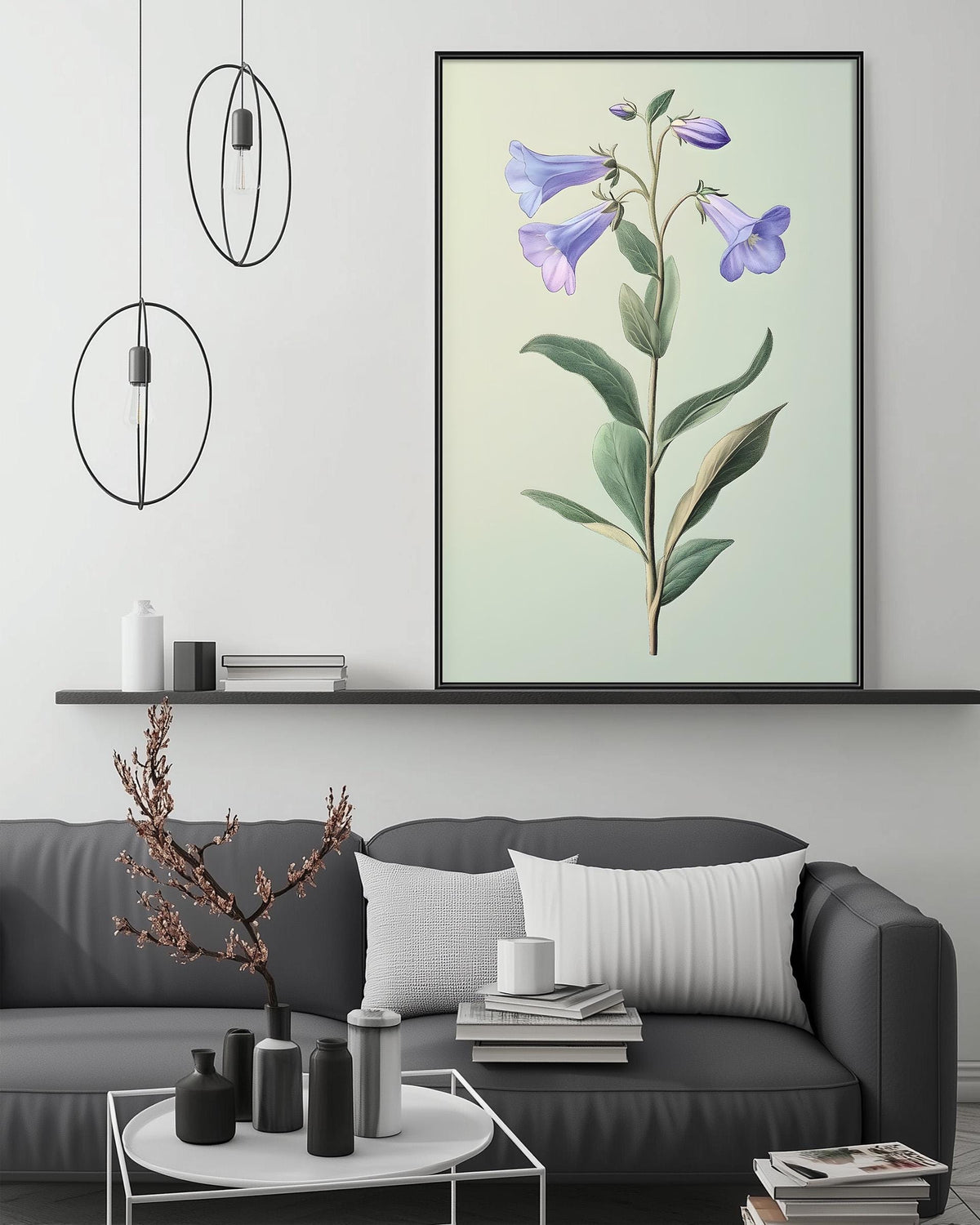 a living room with a gray sofa, a coffee table, and a large framed print of a purple flower on the wall above the sofa.
