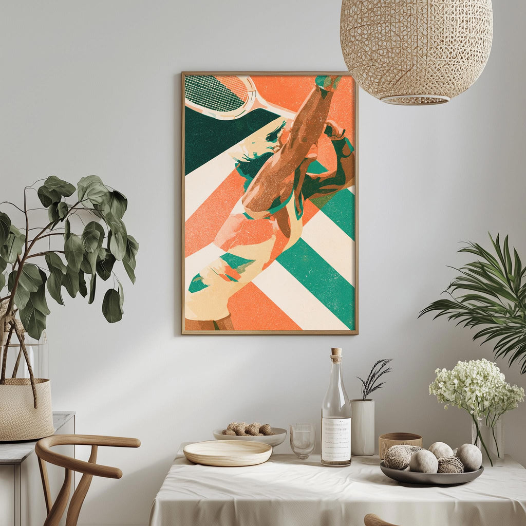 a dining table with a white tablecloth, a bowl of fruit, a bottle, and a vase with flowers. Above the table, there is a framed print of a tennis racket and ball on a striped background.