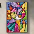 a vibrant, colorful abstract painting of a cat hanging on a wall above a kitchen counter.