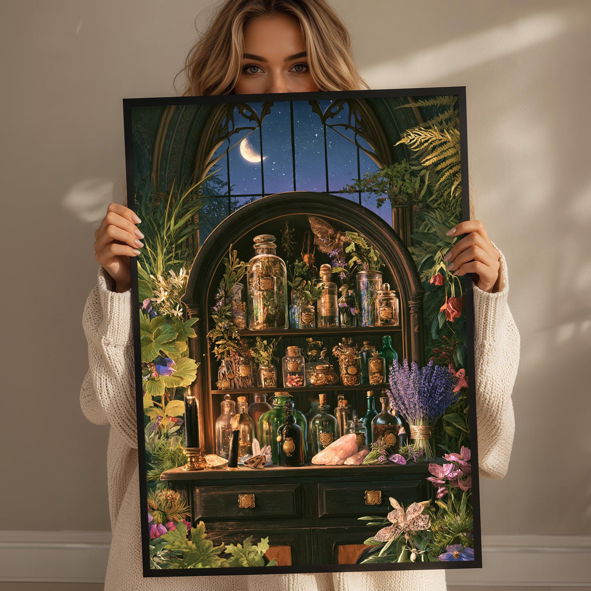 A woman holds up a framed image depicting a whimsical, fantastical scene with a crescent moon, starry night sky, and a shelf filled with various bottles and jars.