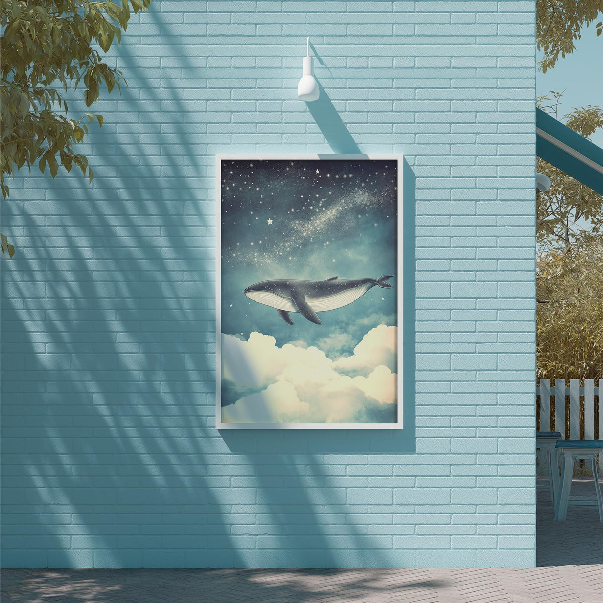 a blue brick wall with a framed painting of a whale swimming in the sky above it.