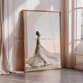 a large framed poster with a silhouette of a person in a flowing dress, standing in front of a window.