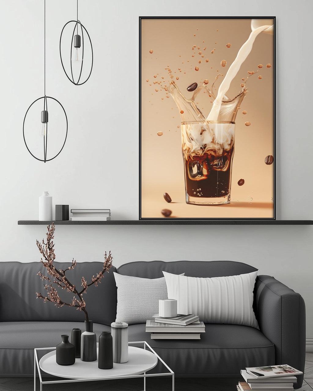 a modern living room with a gray sofa, a coffee table, and a large framed picture of a glass of coffee with milk splashing out of it.