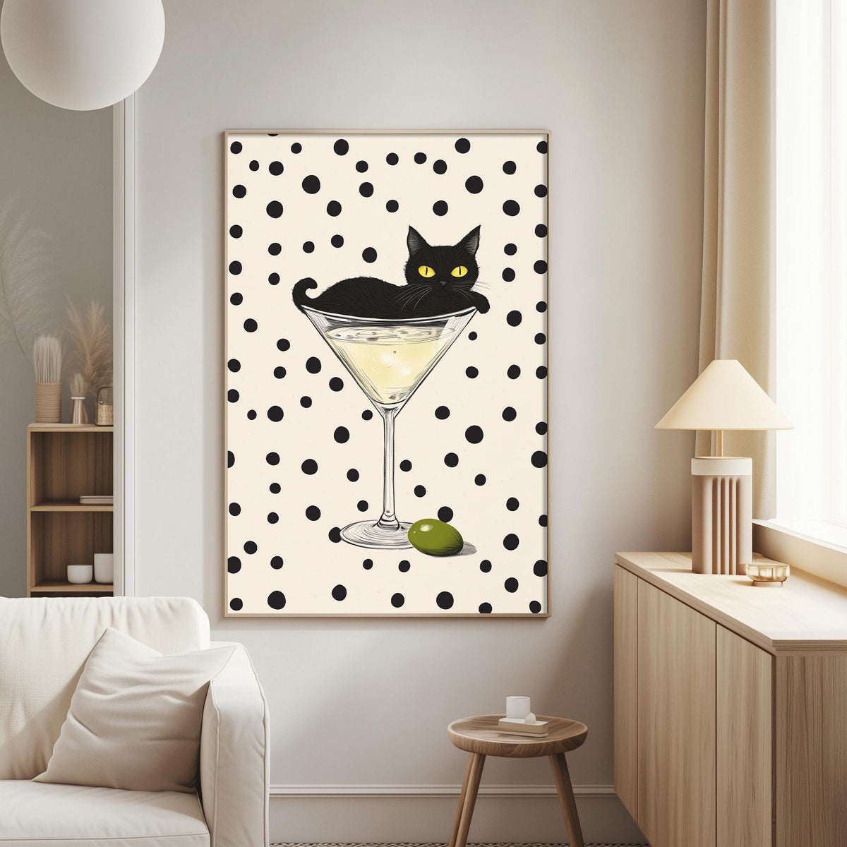 a black cat sitting on a martini glass, which is filled with a yellow liquid, and there is a green olive on the glass.