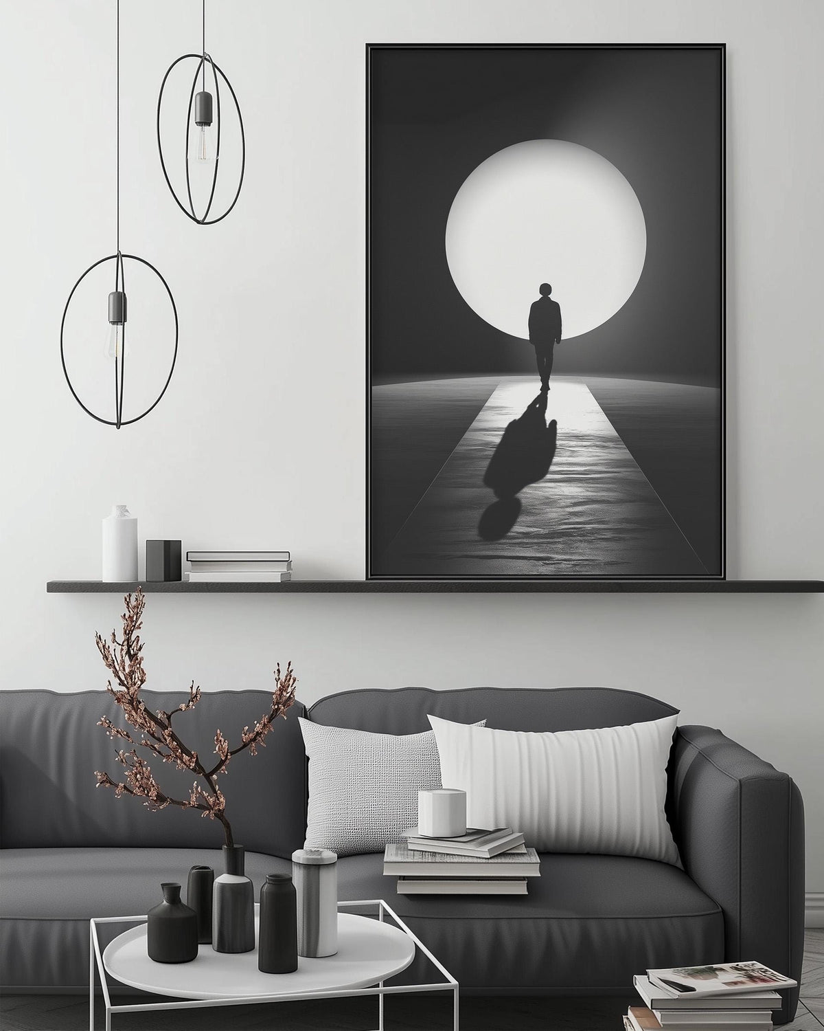 a modern living room with a gray sofa, a coffee table, and a large black and white photograph of a person walking on a path towards a large circular light source.