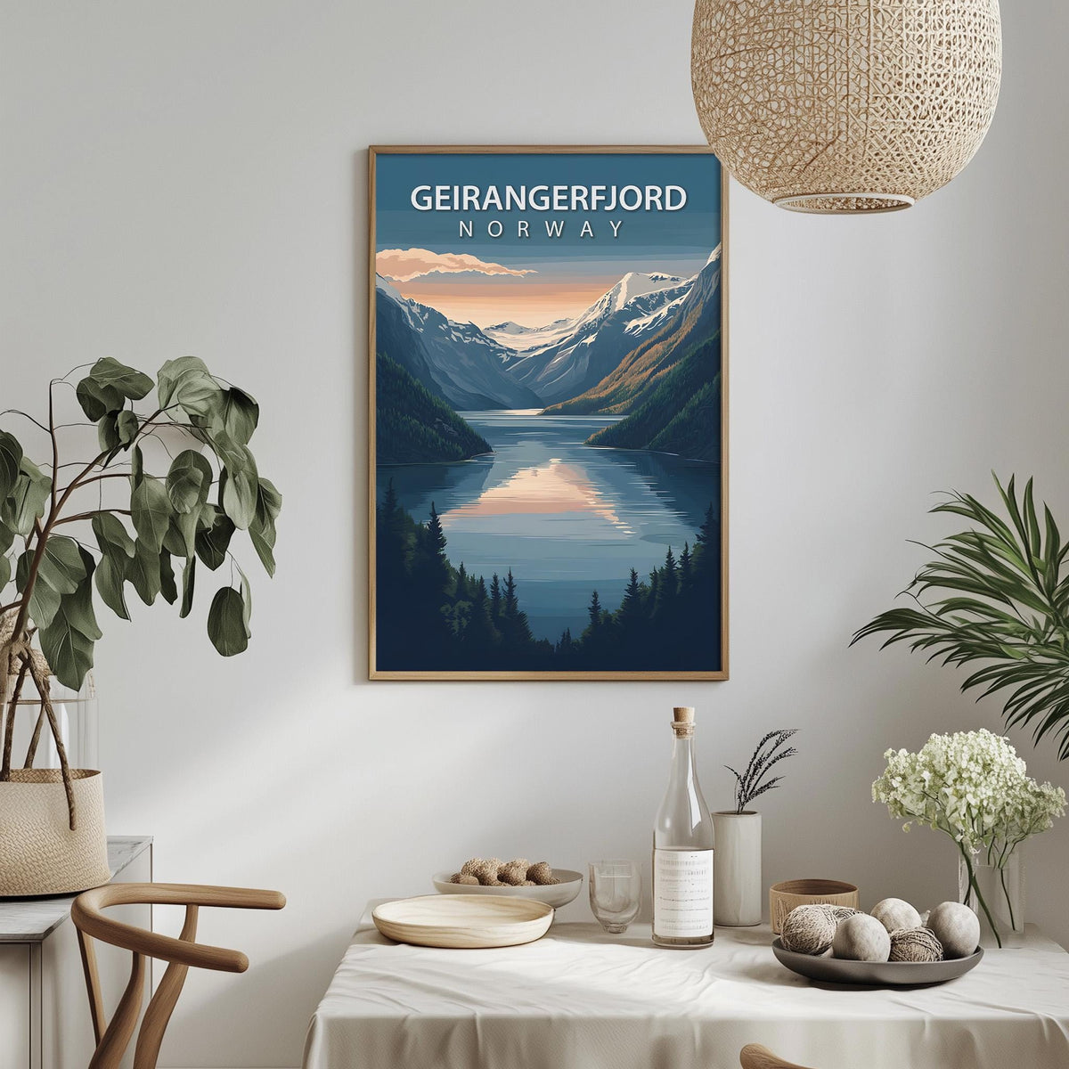 a framed poster of a scenic mountain landscape with a lake, hanging on a wall above a dining table with various decorative items and plants.