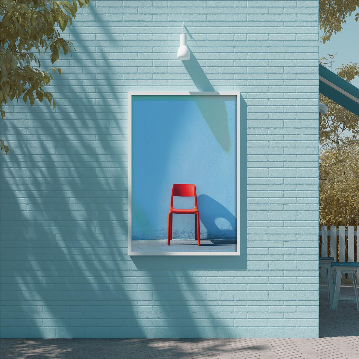 a red chair in a square frame, set against a blue brick wall.