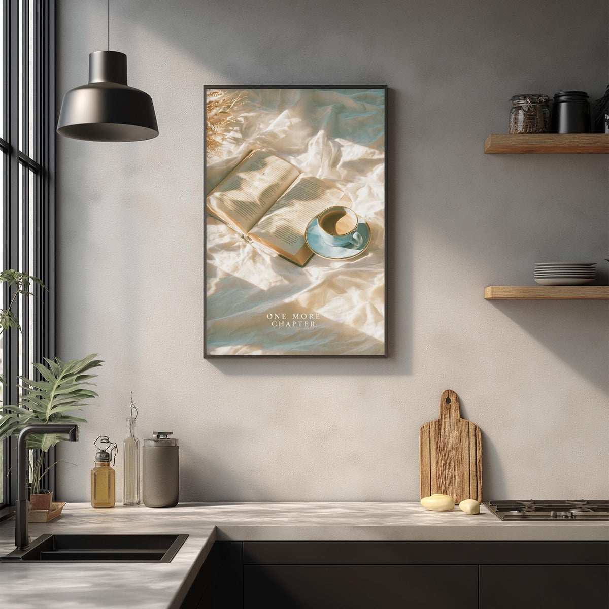 a kitchen counter with various items, including a framed poster of an open book, a teacup, and a wooden cutting board.