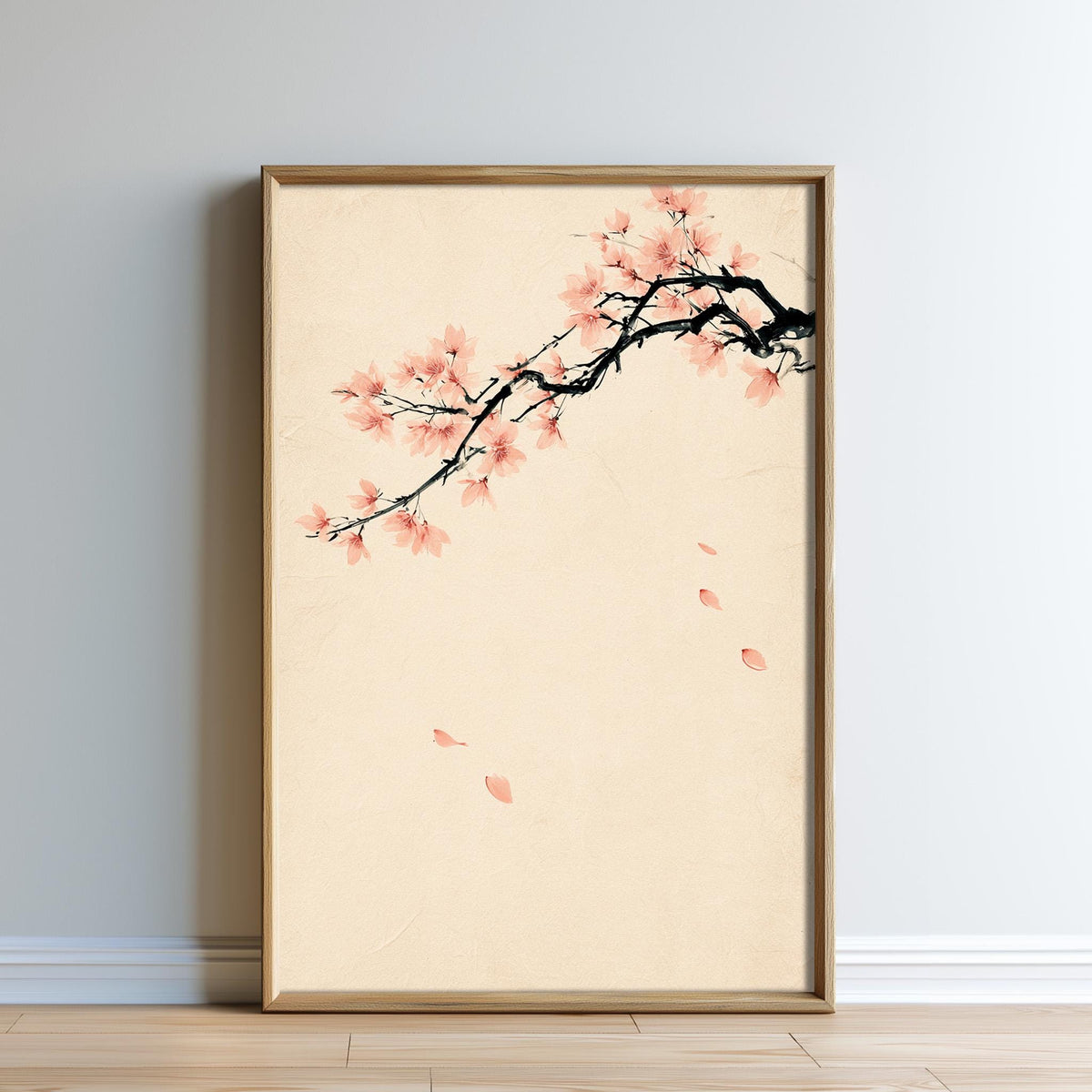 A framed print of a branch with pink flowers is displayed on a wall.