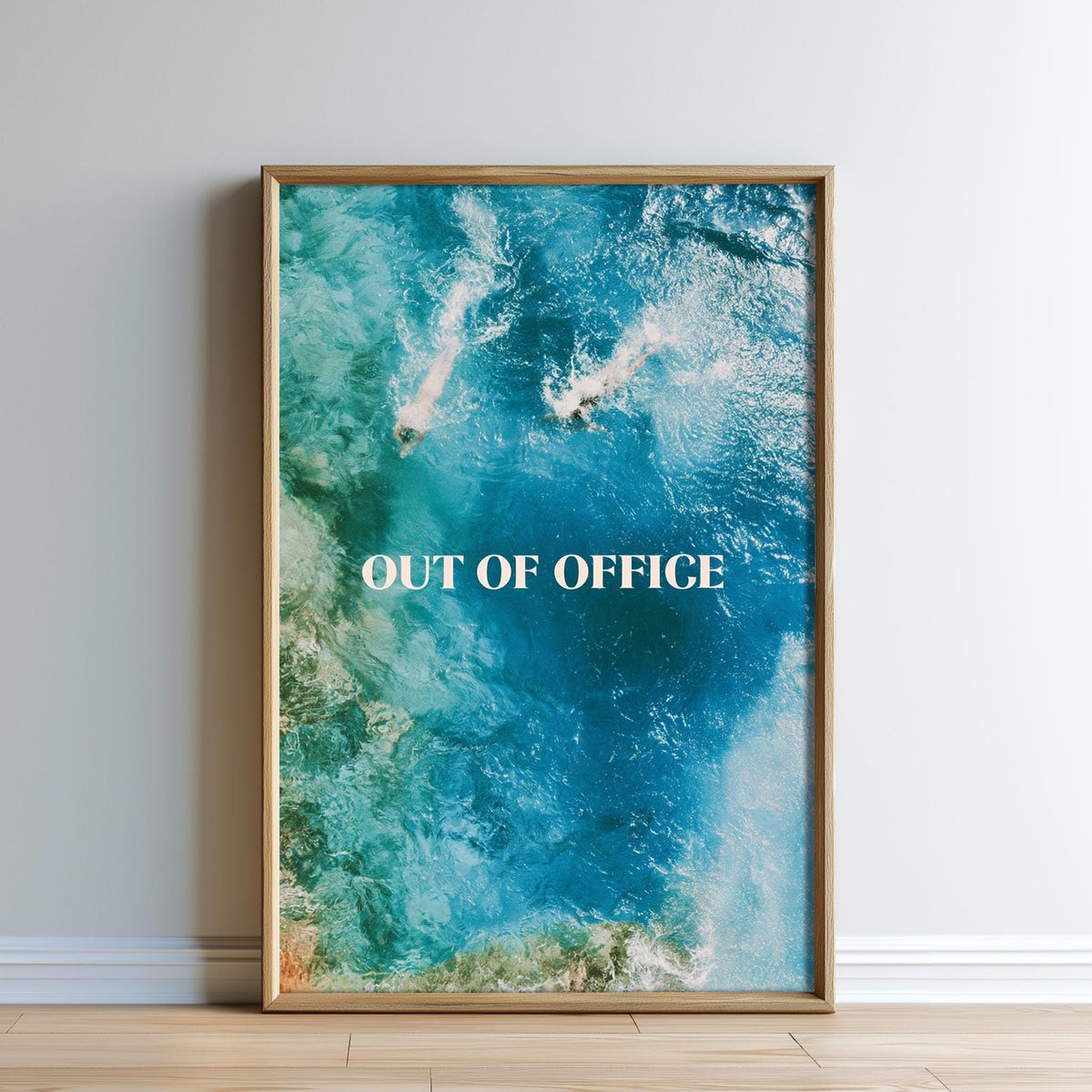 The image is a framed poster with a picture of a beach and the text "OUT OF OFFICE" displayed prominently.