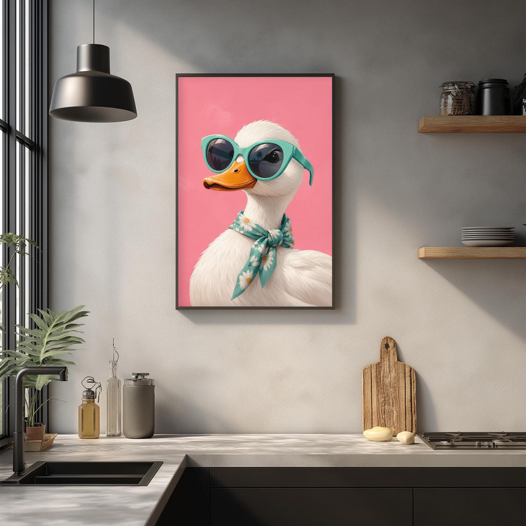 a kitchen counter with a framed picture of a duck wearing sunglasses, a scarf, and a hat, as well as some kitchen items such as a cutting board, a bottle, and a bowl.