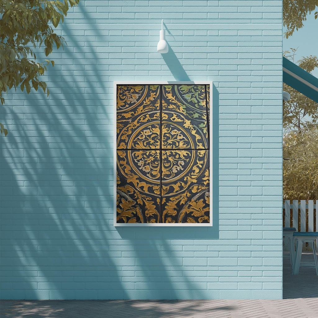 a blue wall with a decorative tile panel hanging on it. The panel has an ornate, intricate design with gold and black elements. The wall is situated next to a wooden deck and a tree, creating a serene and inviting outdoor setting.