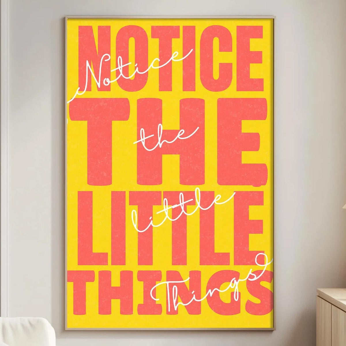 a large, bold, and colorful poster with the text " NOTICE THE LITTLE THINGS" displayed prominently on it.