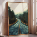 A framed painting depicting a winding road surrounded by trees and foliage, with a hazy, atmospheric background.