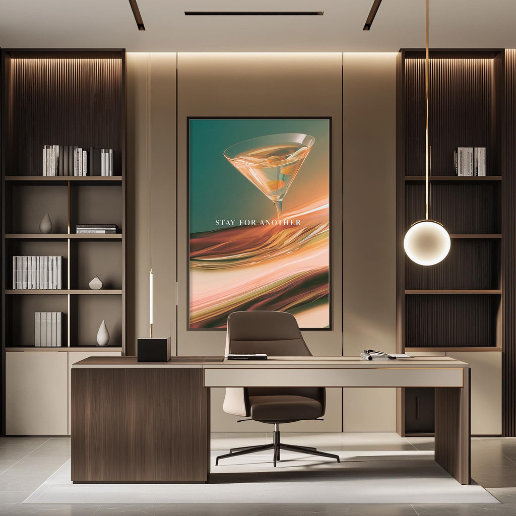 a modern office space with a large framed poster of a cocktail glass on the wall, a wooden desk with a chair, and a bookshelf filled with books.