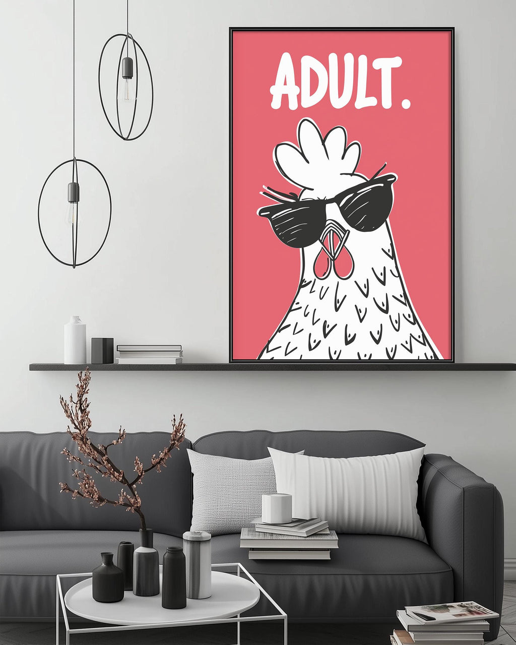 a large, colorful poster of a chicken wearing sunglasses, which is displayed on a wall above a gray couch in a living room setting.