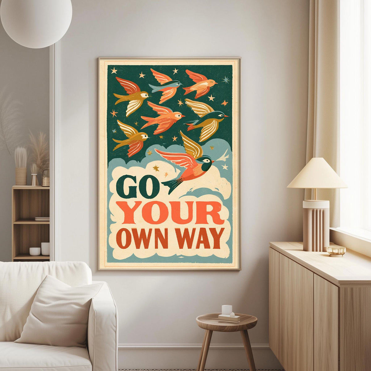 a poster with a bird design and the text "Go Your Own Way" displayed on a wall in a living room setting.