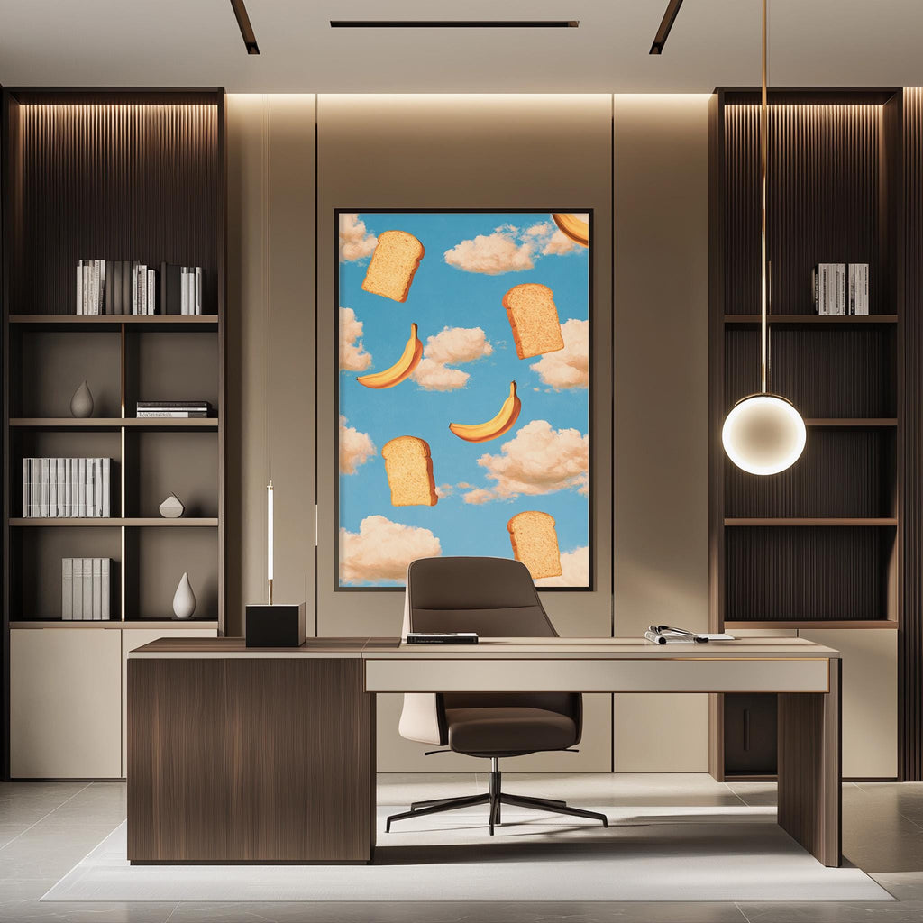 a modern office space with a large framed artwork featuring bananas and clouds on the wall. The office has a wooden desk, a comfortable-looking chair, and a bookshelf filled with books. The overall design and decor create a professional and stylish atmosphere.