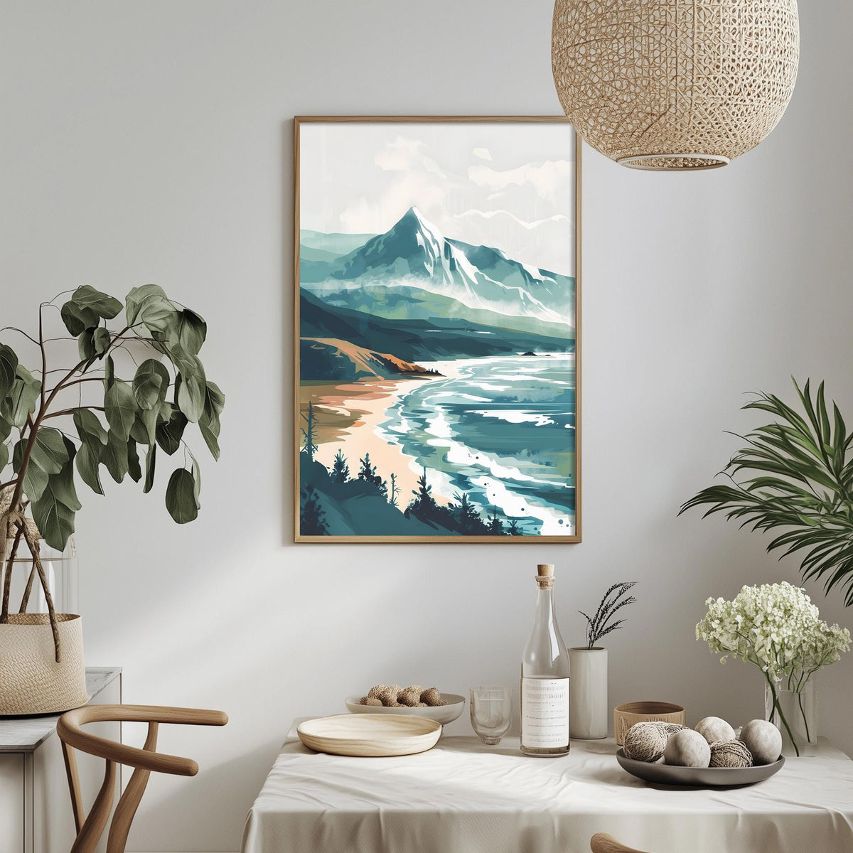 a serene landscape with a mountain range, a beach, and a body of water, all depicted in a painting. The painting is hung on a wall above a dining table, which is set with various items such as a bottle, a bowl, and a vase. The table is surrounded by chairs, creating a cozy and inviting atmosphere. The overall scene conveys a sense of tranquility and natural beauty.