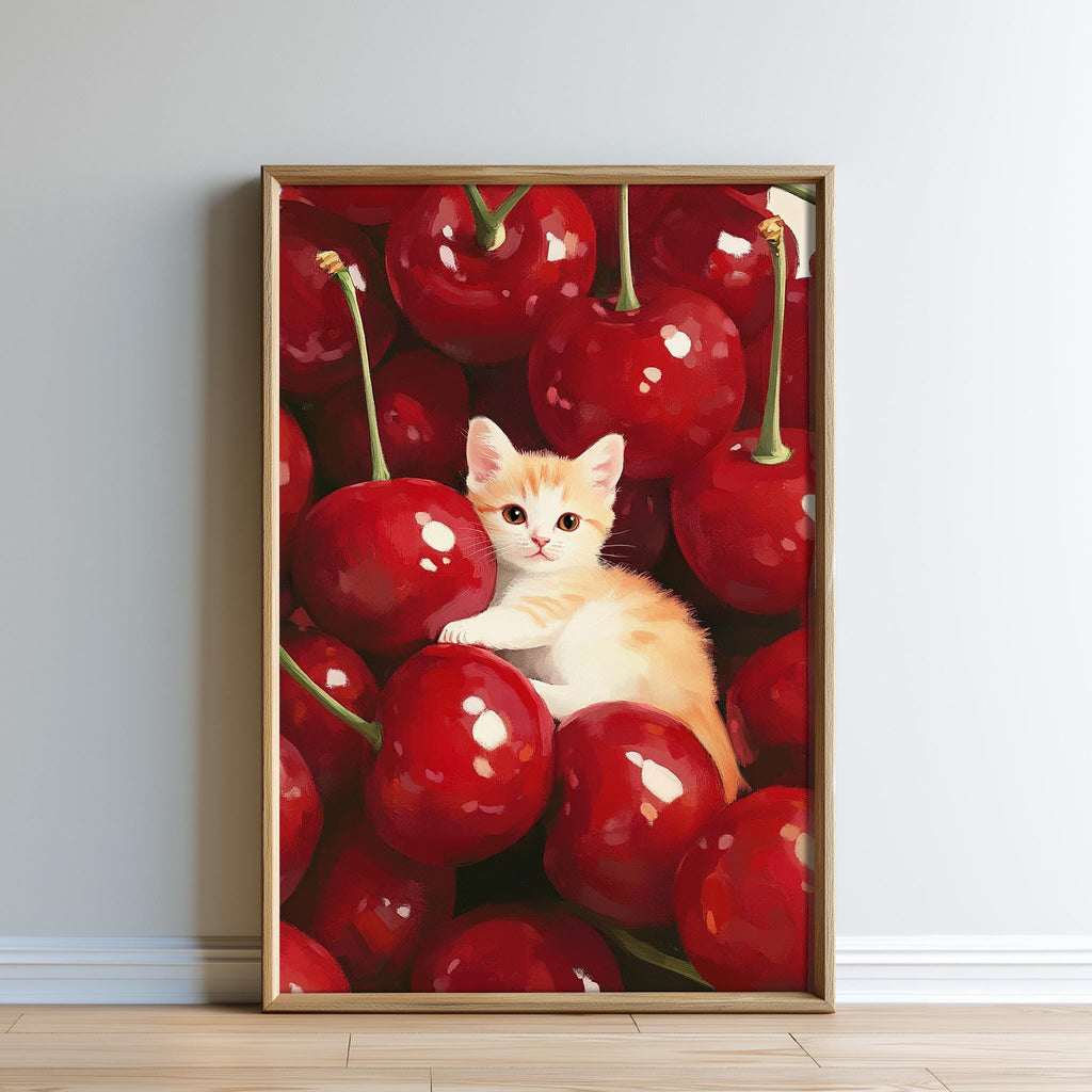 A framed painting depicting a small orange and white cat sitting among a pile of red cherries.