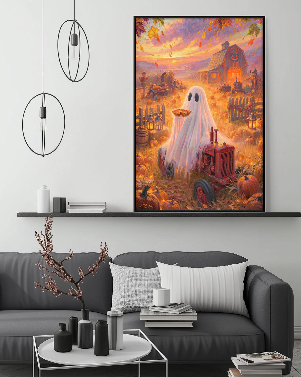 a large, colorful painting of a ghost in a field with a red tractor, surrounded by autumn foliage and pumpkins. The painting is displayed on a wall above a gray couch, which has a coffee table and various decorative items on it.