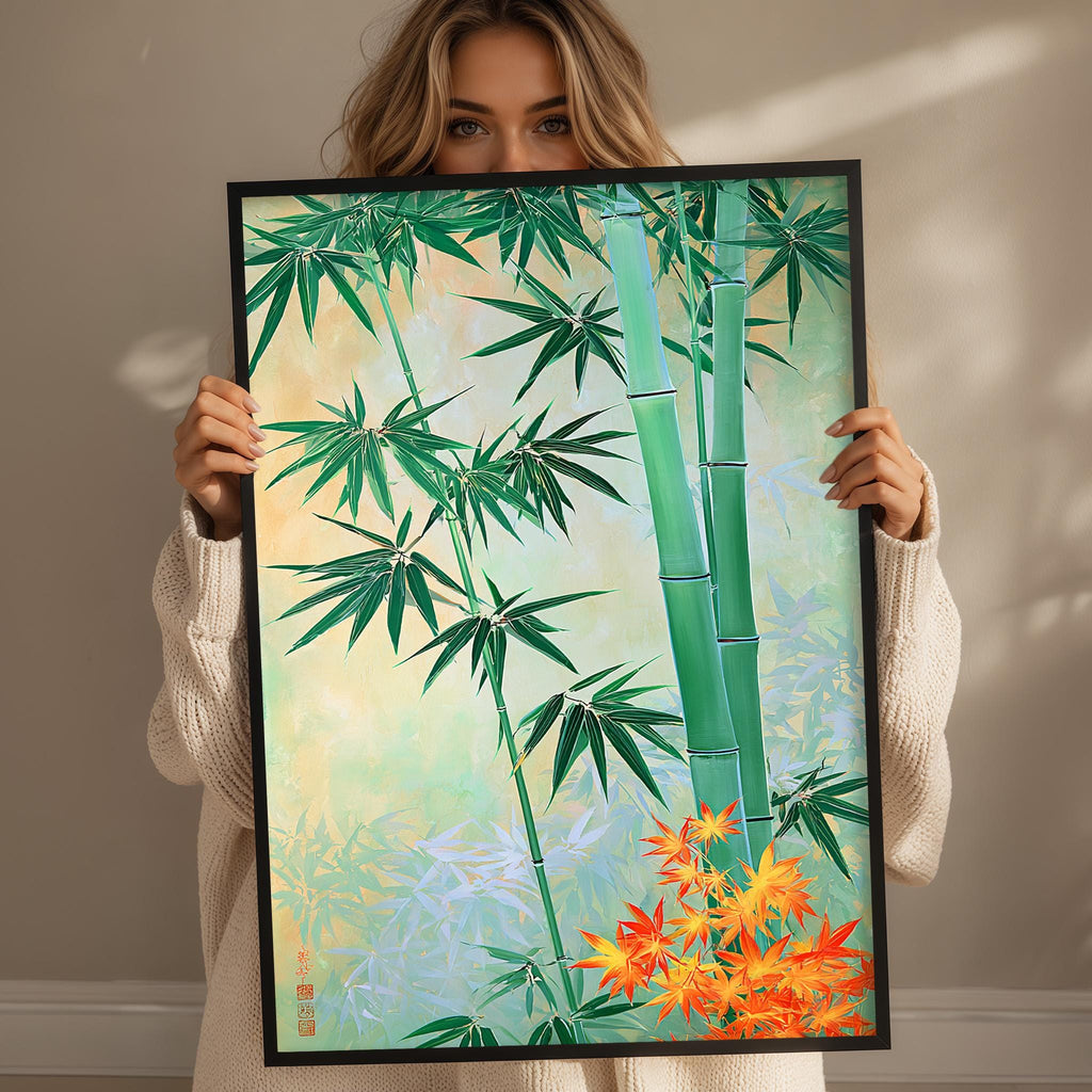 A woman holds up a framed painting of a bamboo forest with green leaves and orange flowers.
