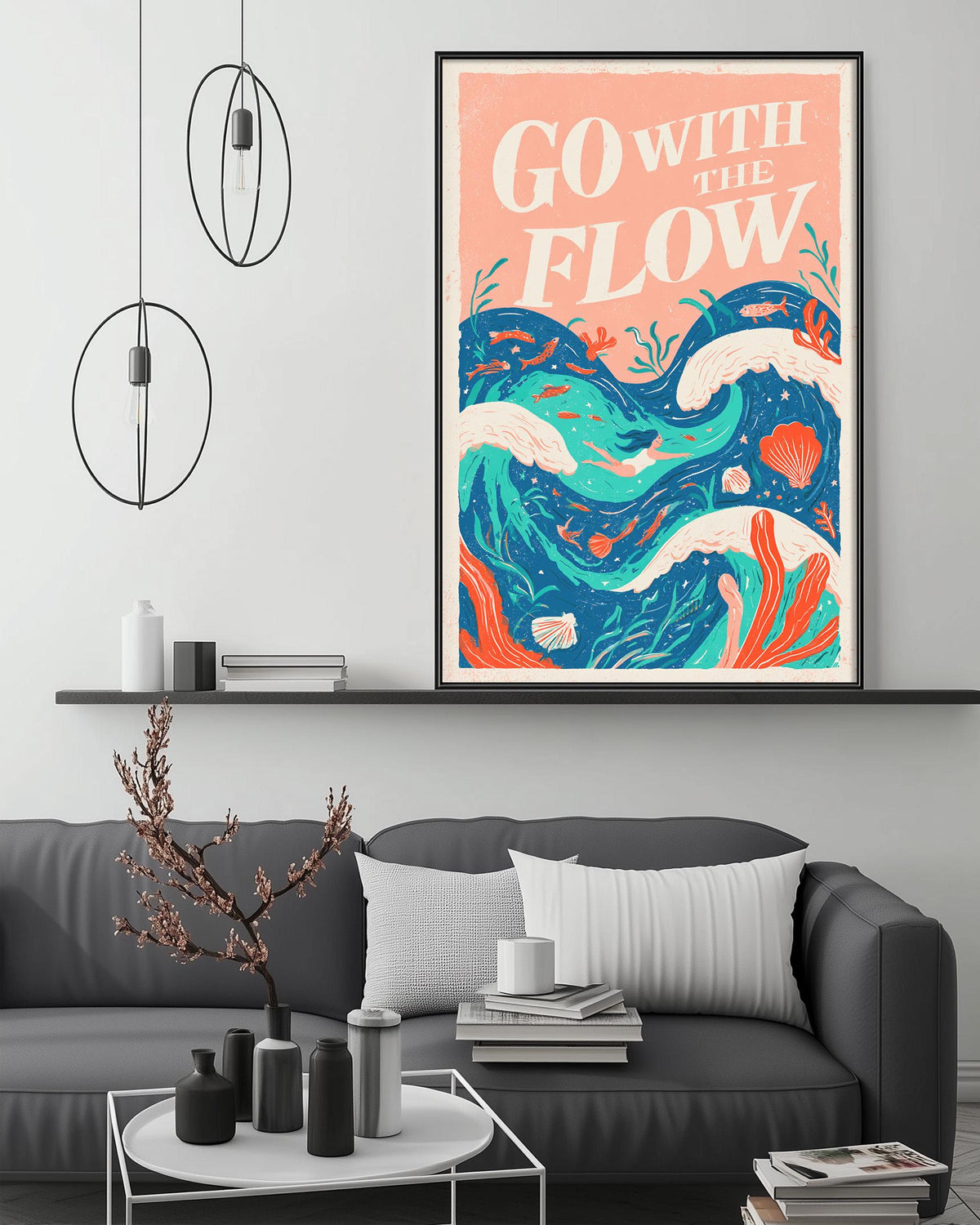 a living room with a gray couch, a coffee table, and a framed poster with a colorful ocean scene hanging on the wall.