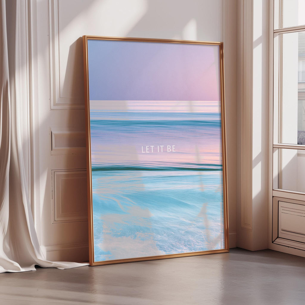 A large framed poster with a seascape design, featuring a gradient of colors and the text "LET IT BE" in the center.