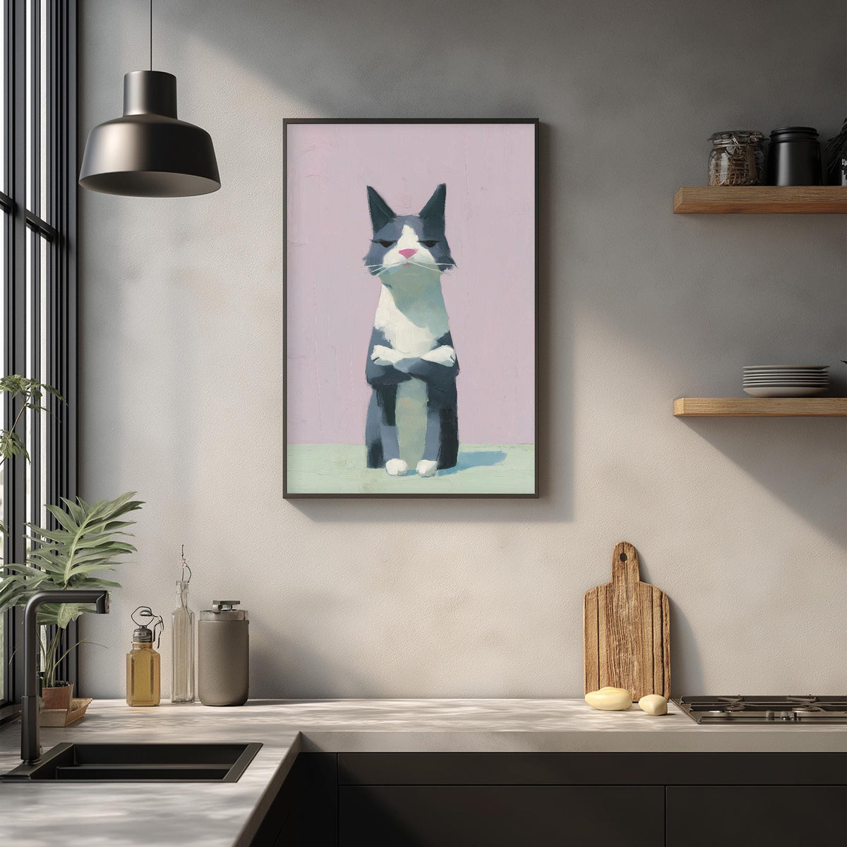 a kitchen counter with a framed picture of a cat hanging on the wall above it. The kitchen counter also has various items such as a cutting board, a bottle, and a plant.