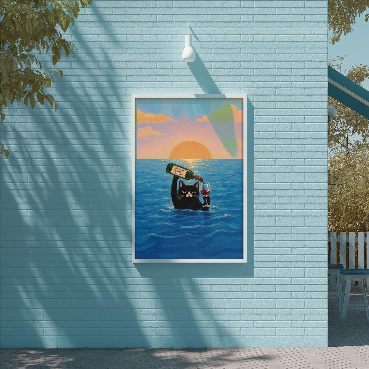 A framed illustration of a cat swimming in the ocean, holding a bottle of wine, with a sunset in the background.
