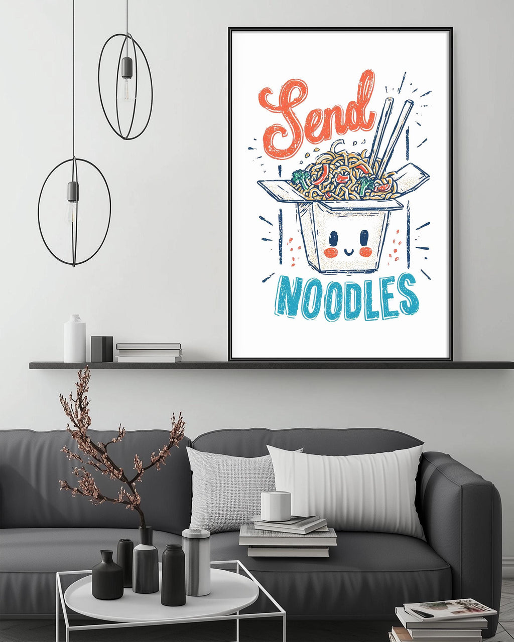 a cozy living room with a gray couch, a coffee table, and a framed poster of noodles with a smiling face. The poster has the text "Send Noodles" written on it.