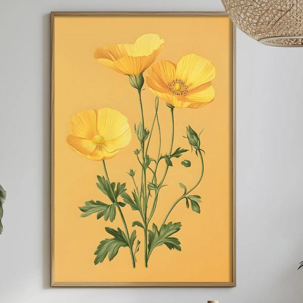 a dining table with a white tablecloth, a bowl of fruit, a bottle, and a vase with flowers. Above the table, there is a framed picture of yellow flowers hanging on the wall.