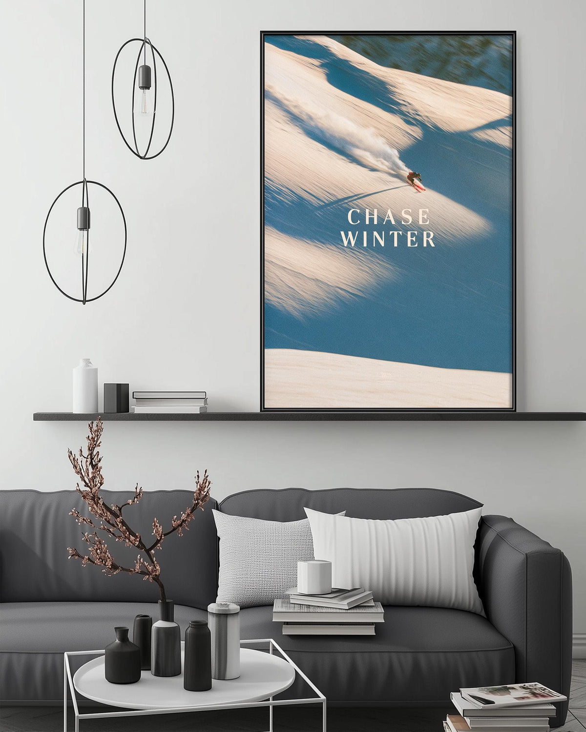 a cozy living room with a gray sofa, a coffee table, and a large framed poster of a snowboarder on the wall.