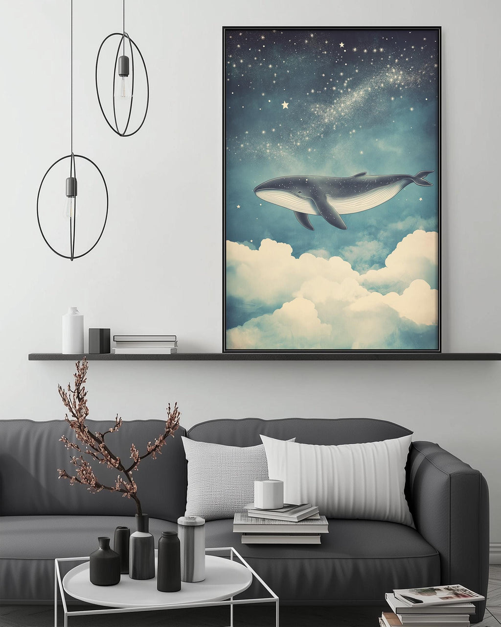 a large framed artwork depicting a whale flying through a starry night sky, hanging on a wall above a gray couch with a coffee table in front of it.