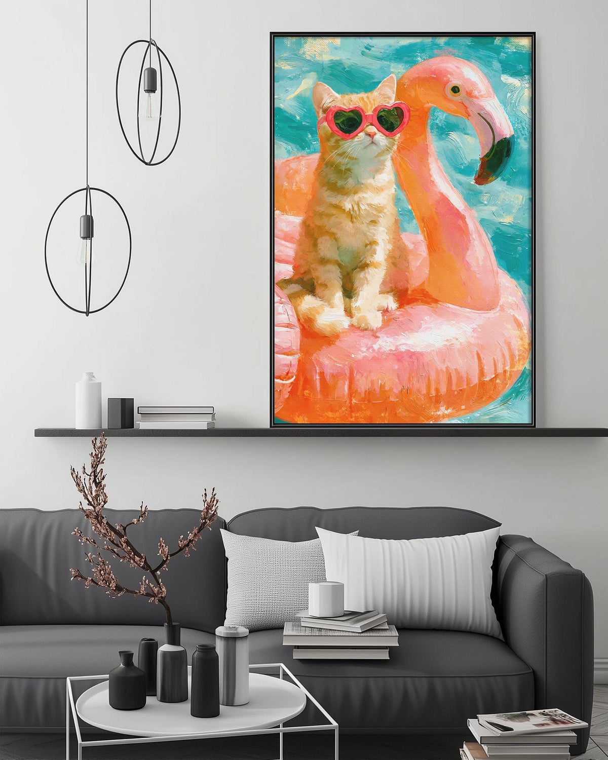 A framed painting of a cat wearing sunglasses and sitting on a pink flamingo float, with a gray couch and a coffee table in the foreground.