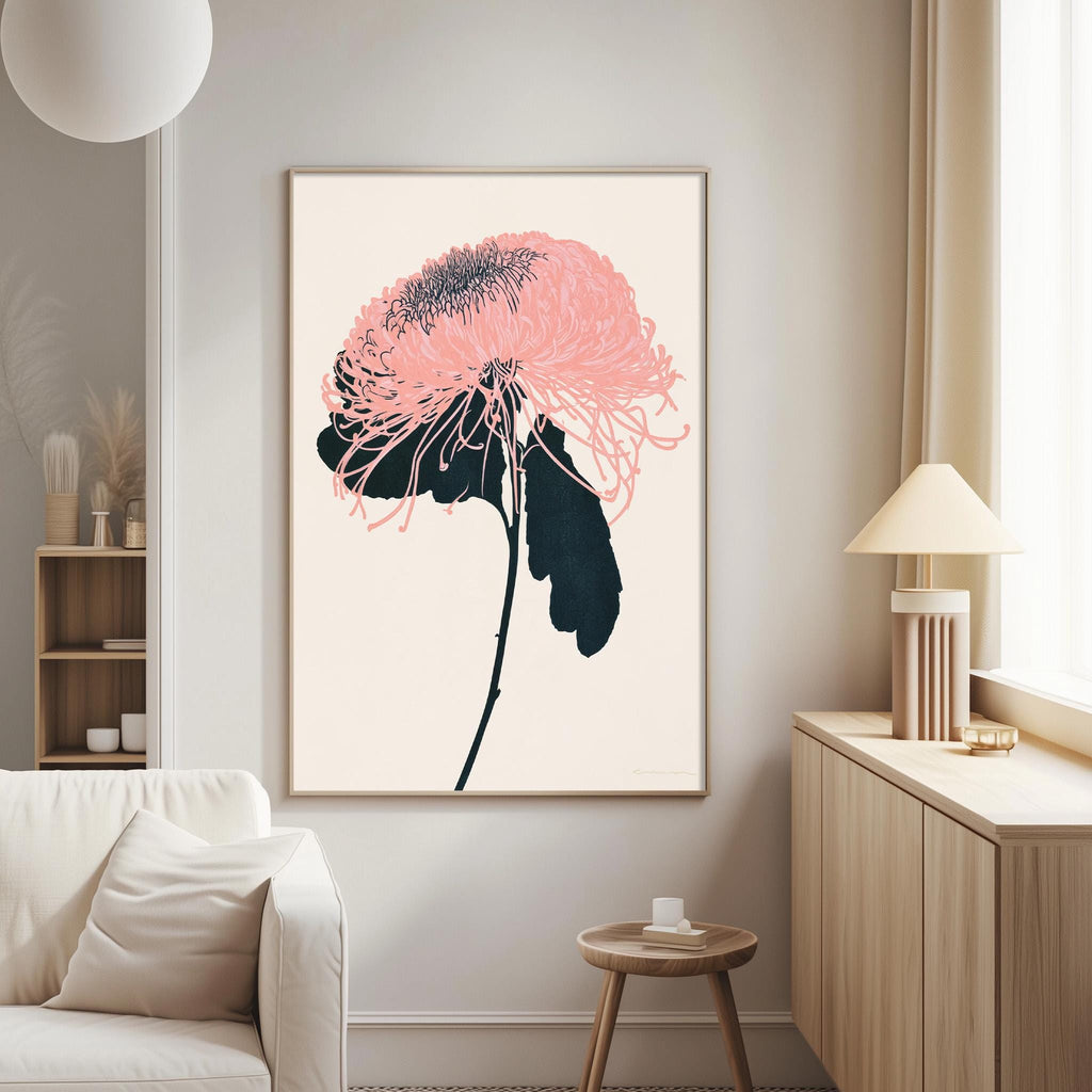 a living room with a large framed artwork of a pink flower on the wall. The artwork is the focal point of the room, with a white sofa and a wooden side table nearby.