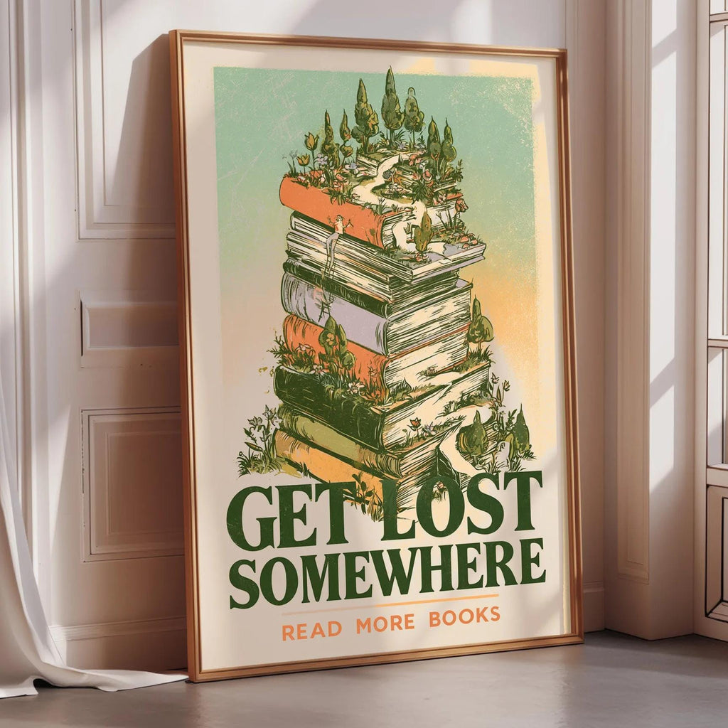A framed poster with a stack of books on top, surrounded by a forest scene, and the text "GET LOST SOMEWHERE READ MORE BOOKS" is displayed on a wall.