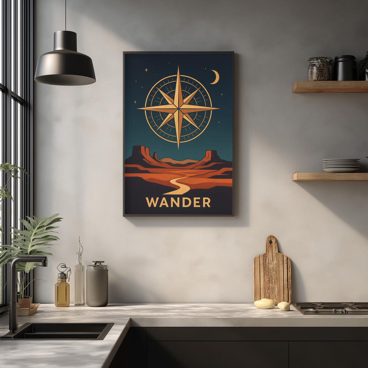 a kitchen counter with a framed poster of a desert landscape and a compass on the wall above it.