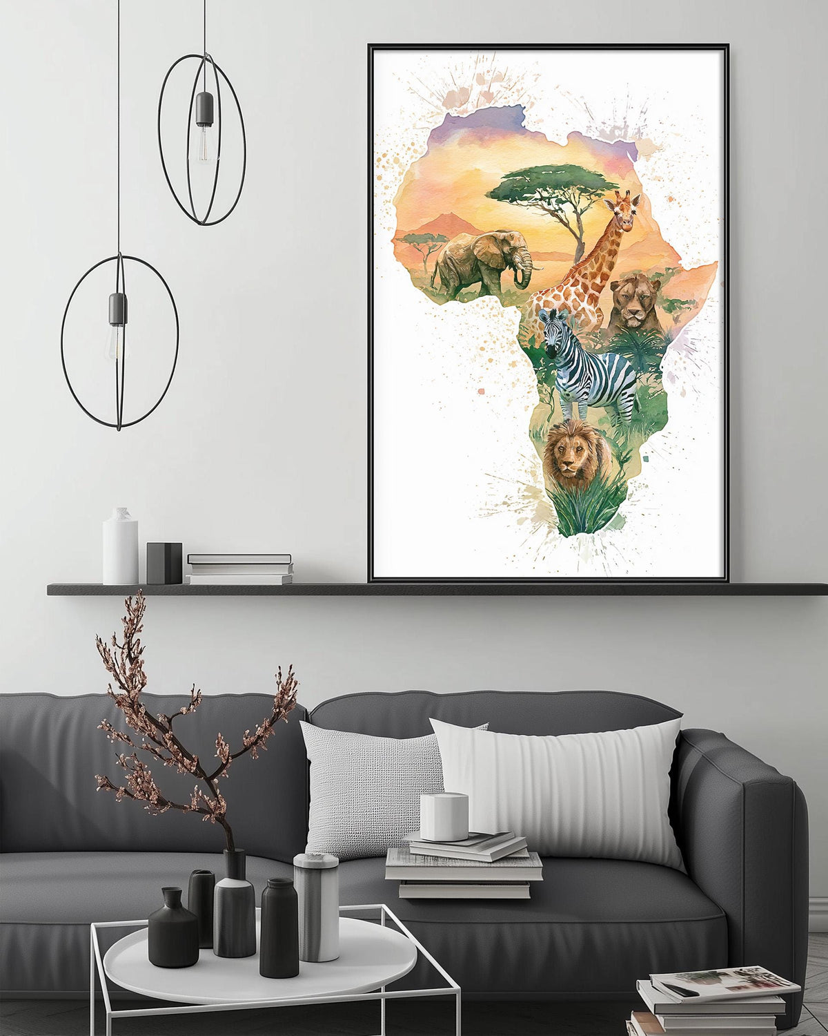 a large framed print of an African landscape with various animals, including elephants, giraffes, zebras, and lions, set against a colorful background. The print is displayed on a wall above a gray couch, which is positioned in front of a coffee table. The room has a minimalist and modern design, with a pendant light hanging above the couch and a shelf below the print.