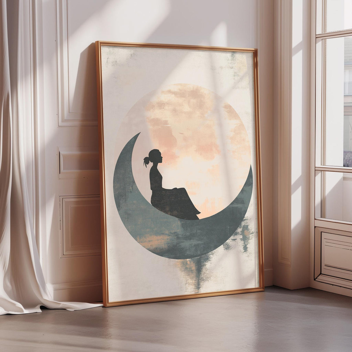 a framed artwork depicting a silhouette of a person sitting on a crescent moon.