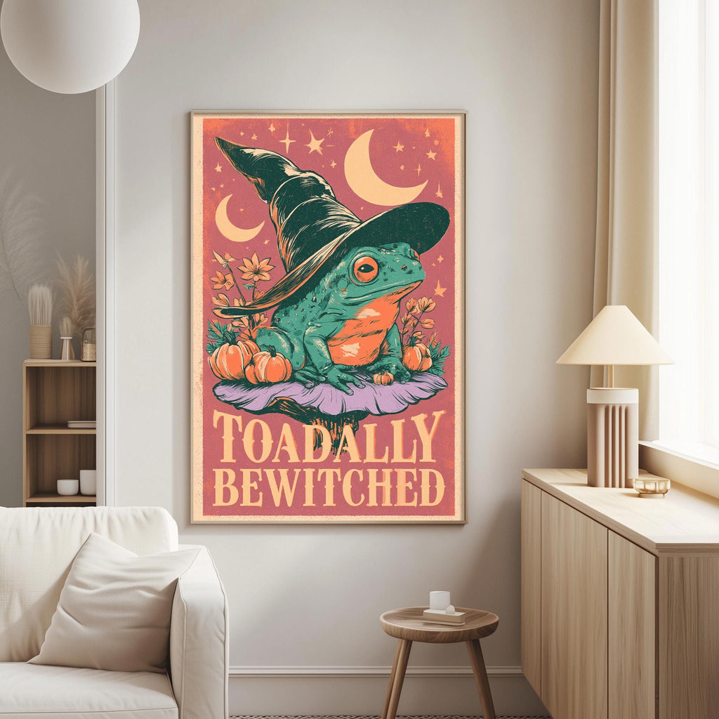 a poster of a frog wearing a witch's hat, surrounded by flowers and crescent moons, with the text "Toadally Bewitched" displayed on it.