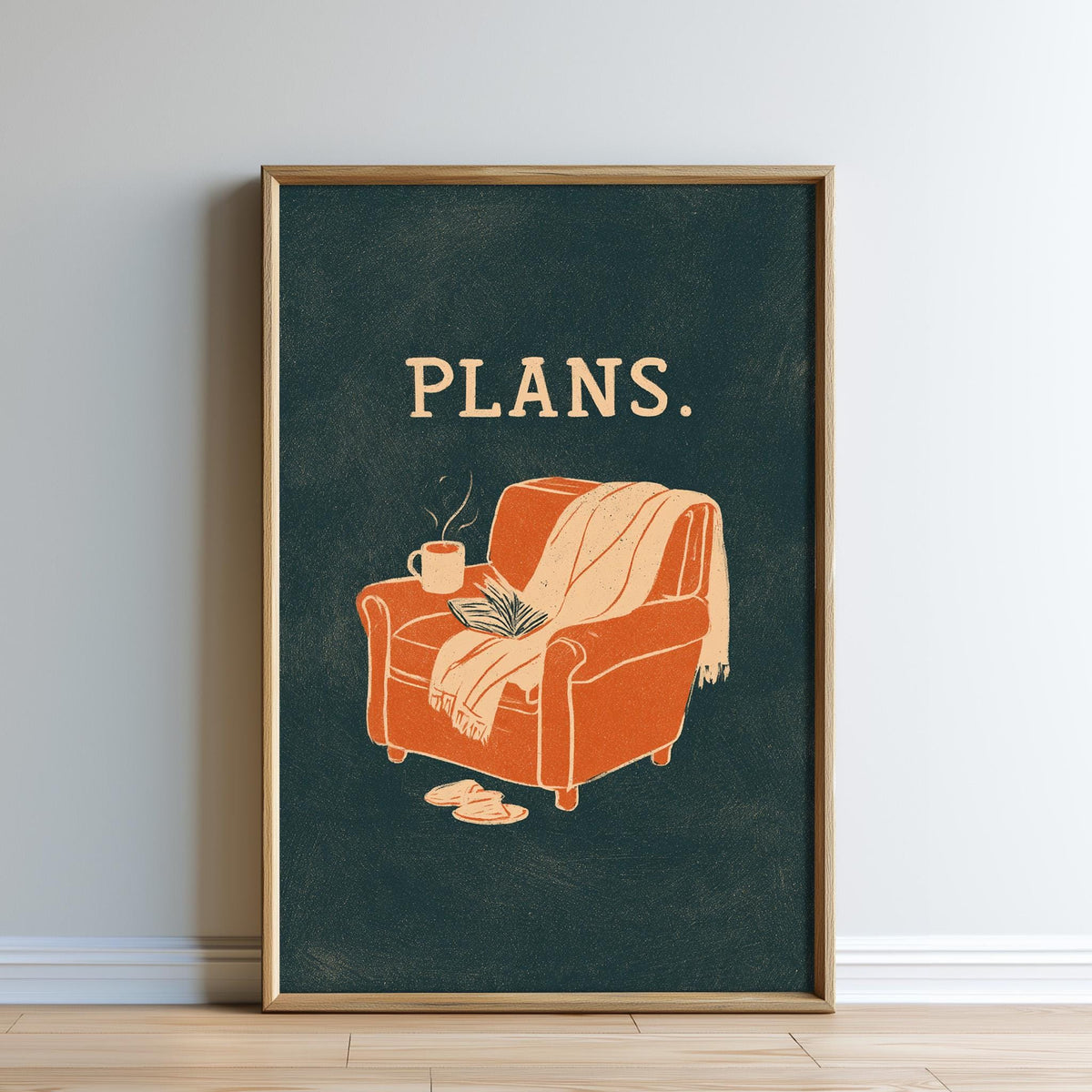 A framed poster with an illustration of a cozy armchair and a cup of coffee, accompanied by the word "PLANS."